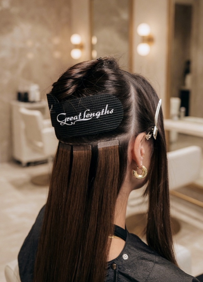Great Lengths GL Tapes fitted in-salon, sitting flat and hidden beneath the top layers of hair