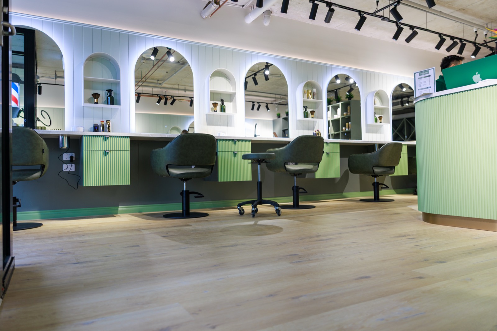 Hair Avenue Braddon — signature arched styling stations with olive leather chairs