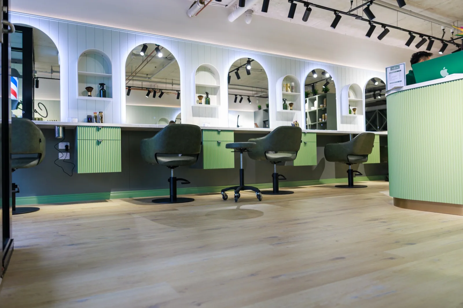 Hair Avenue Braddon — signature arched styling stations with olive leather chairs
