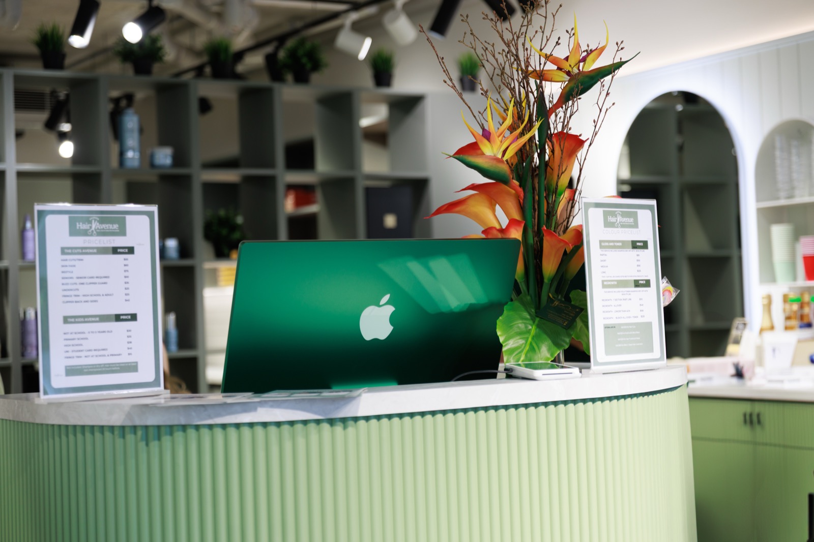 Warm reception counter with fresh flowers at Hair Avenue Braddon