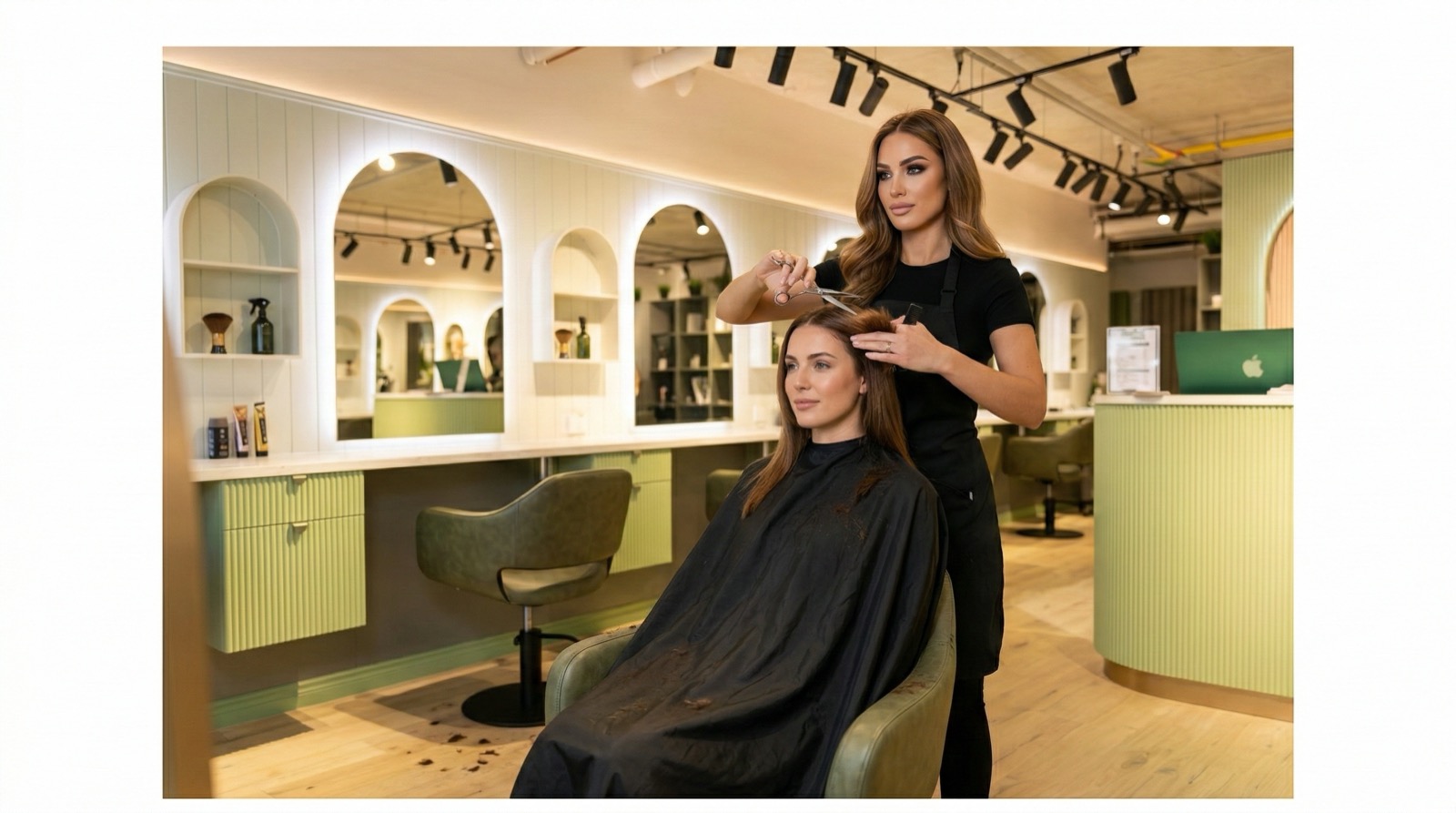 Hair Avenue stylist cutting a client's hair at the styling chair, arched mirrors behind
