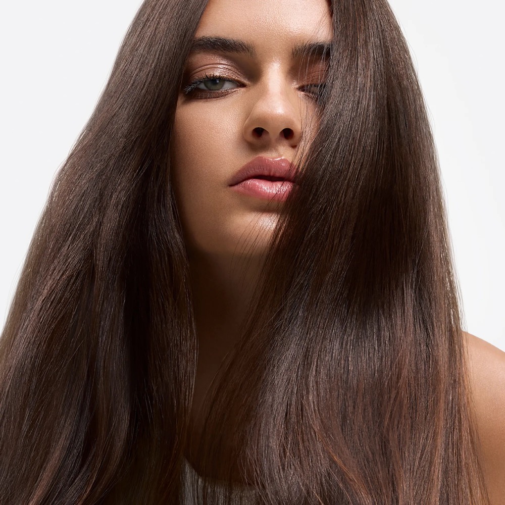Sleek, glossy brunette hair — the smooth, frizz-free finish nanoplasty is designed to give